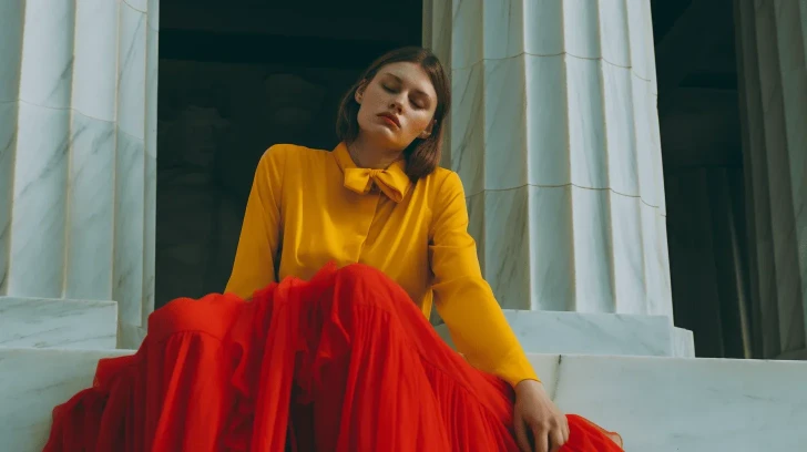 Yellow blouse with bow tie and red flowing skirt, elegant fashion style, ideal for formal events or evening wear.