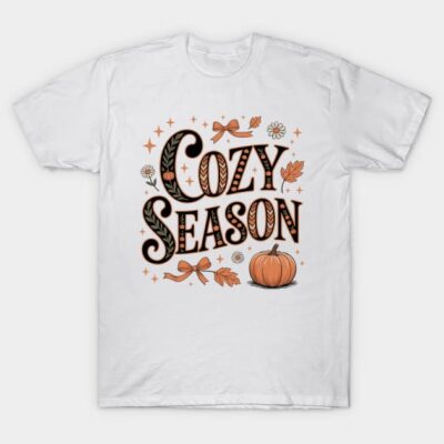 White t-shirt with "Cozy Season" text, fall-themed design including pumpkin and leaves, made of cotton, casual wear.