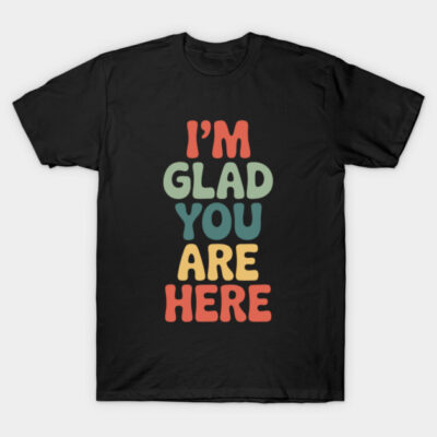Black T-shirt with colorful "I'm Glad You Are Here" text design, casual and comfortable cotton material.