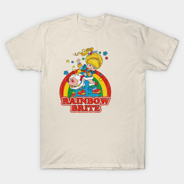 Retro beige t-shirt with colorful cartoon print and "Rainbow Brite" text, perfect for casual wear and vintage style lovers.