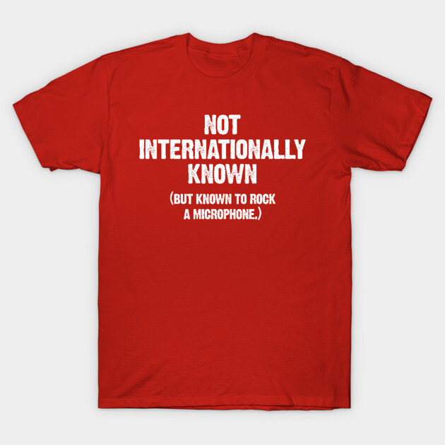 Red graphic t-shirt with "Not Internationally Known" text, casual style, cotton material, unisex design.