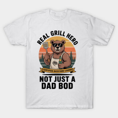 White t-shirt with "Real Grill Hero" bear graphic, BBQ-themed novelty gift, perfect for outdoor cooking enthusiasts.