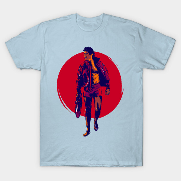 Light blue t-shirt with graphic design of a person in a jacket on a red circle background, casual wear.