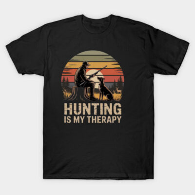 Black hunting-themed t-shirt with sunset graphic, featuring hunter and dog silhouette, text "Hunting is My Therapy".