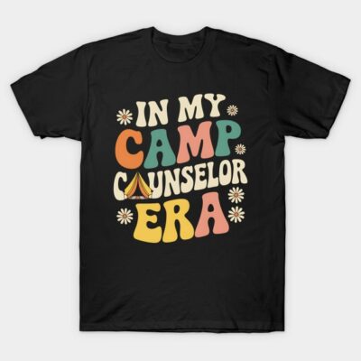 Black T-shirt with colorful retro text "In My Camp Counselor Era," casual summer style, perfect for outdoor enthusiasts.