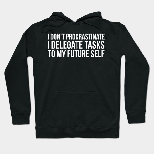 Black hoodie with humorous white text, "I Don't Procrastinate, I Delegate Tasks to My Future Self," casual wear.