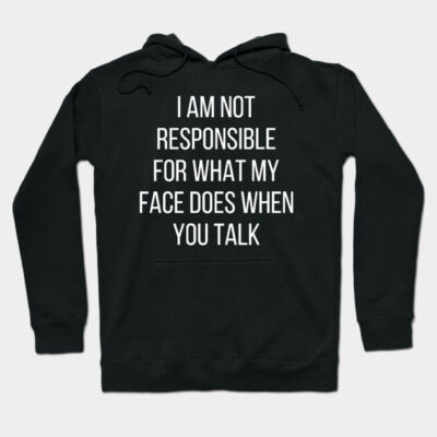 Black hoodie with humorous white text saying "I am not responsible for what my face does when you talk." Casual wear.