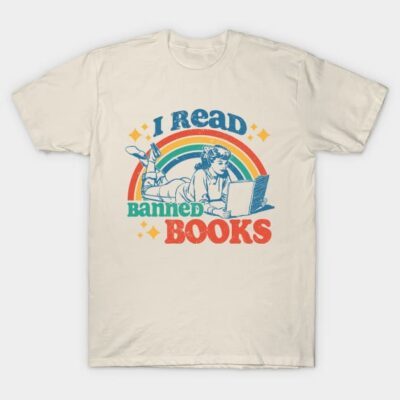 Beige T-shirt with "I Read Banned Books" design, featuring colorful text and vintage style graphic of a person reading.