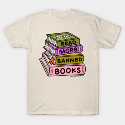 Cream t-shirt with colorful stacked books design featuring "Read More Banned Books" text, casual style.