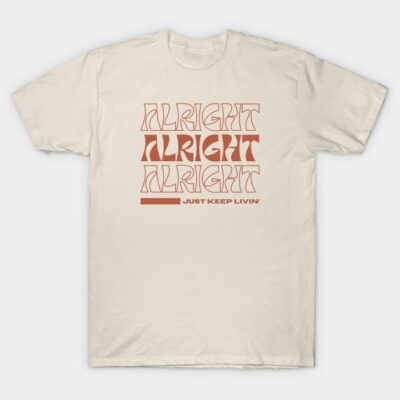 Cream graphic tee with "Alright Alright Alright" text in bold red font, casual style, cotton material.