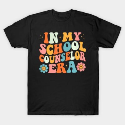 Black t-shirt with colorful "In My School Counselor Era" text design, featuring retro style and floral accents.
