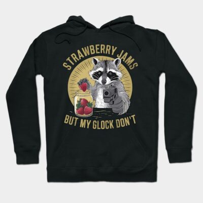 Black hoodie with raccoon graphic holding a strawberry and a jar, text "Strawberry Jams But My Glock Don't", casual wear.