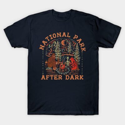Navy blue t-shirt featuring a "National Park After Dark" design with forest and campfire graphic, casual style.