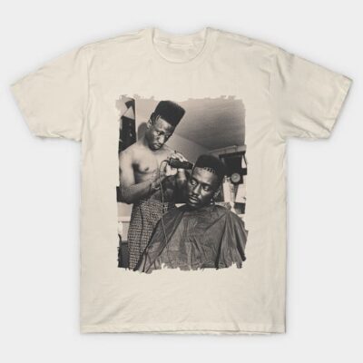 Cream graphic tee with vintage barber scene, cotton material, casual style, perfect for everyday wear.