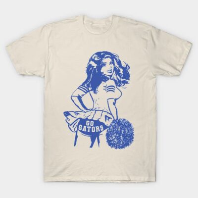 Cream t-shirt with blue cheerleader graphic and "Go Gators" text, casual cotton style, perfect for sports fans.