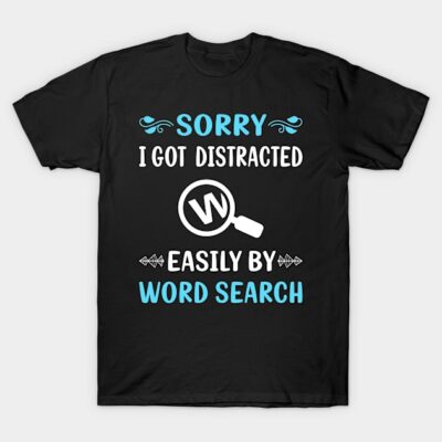 Black t-shirt with "Sorry I Got Distracted by Word Search" design in white and blue text, casual style.