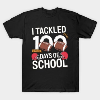 "Black t-shirt with 'I Tackled 100 Days of School' text, football graphics, perfect for school celebrations."