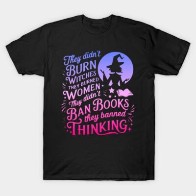 Black T-shirt with witch-themed design and quote in blue and pink text, casual wear, cotton material.