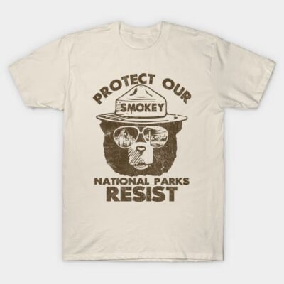 Cream t-shirt with "Protect Our National Parks Resist" graphic, featuring a bear in a ranger hat. Organic cotton material.