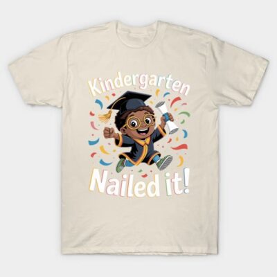 Beige t-shirt with "Kindergarten Nailed It" design, featuring a cartoon graduate in cap and gown, colorful confetti accents.