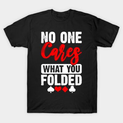 Black poker-themed t-shirt with "No One Cares What You Folded" text in red and white, casual style.