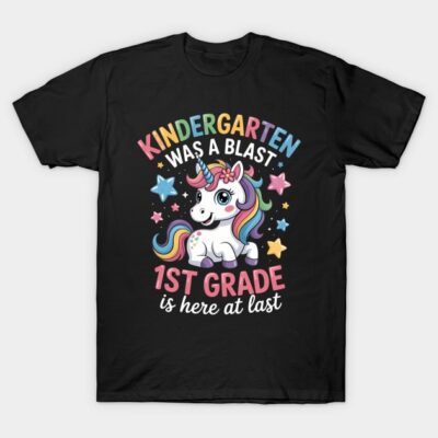 Black t-shirt with colorful "Kindergarten Was a Blast, 1st Grade Is Here" text and a cute unicorn graphic design.
