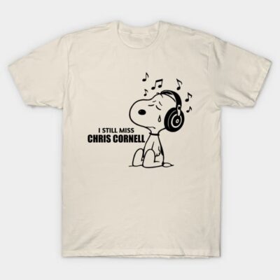 Beige t-shirt with cartoon dog wearing headphones, musical notes, and "I Still Miss" text. Casual wear, cotton material.