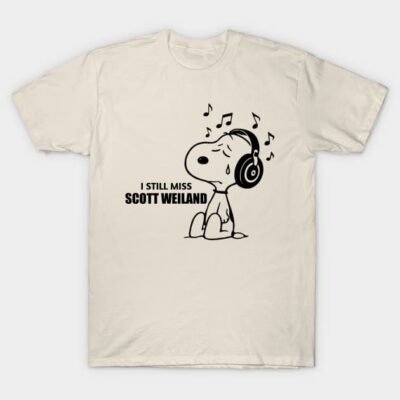 Beige graphic T-shirt with cartoon dog wearing headphones and text "I Still Miss Scott Weiland", casual cotton fabric.