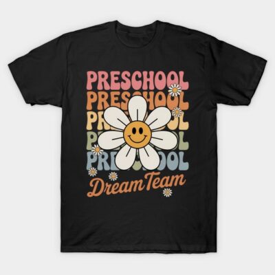 Black "Preschool Dream Team" t-shirt with colorful text and smiling daisy graphic, perfect for casual wear.