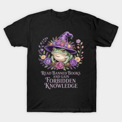 Black t-shirt with whimsical frog in witch hat design, floral accents, and "read banned books" text. Ideal for book lovers.