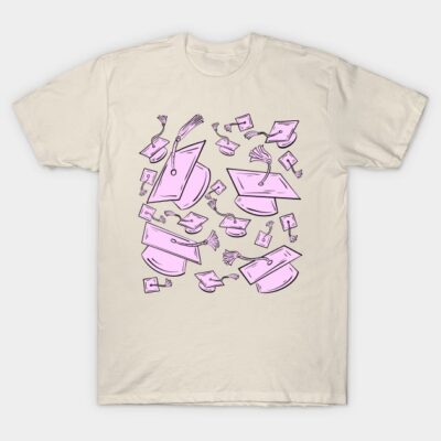 Cream T-shirt with pink graduation cap pattern, casual style, perfect for celebrations or educational events.