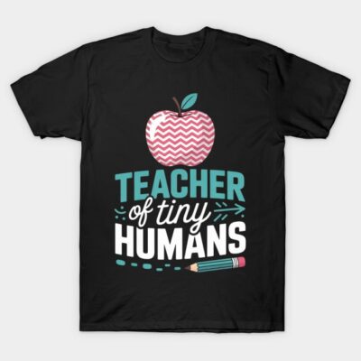 Black T-shirt with "Teacher of Tiny Humans" text, featuring apple and pencil graphic. Ideal for educators, cotton material.