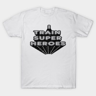 White cotton t-shirt with "I Train Superheroes" text in bold black font, casual style for everyday wear.