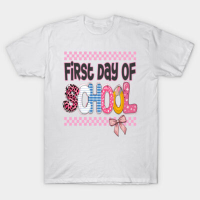 White "First Day of School" graphic t-shirt, colorful letters, playful style, ideal for back-to-school wear.