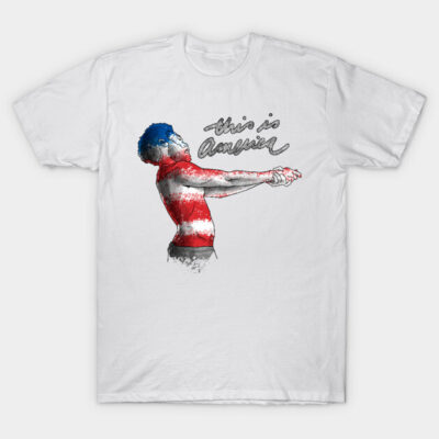 White t-shirt with artistic American flag design, featuring "This is America" text. Casual wear, cotton material.