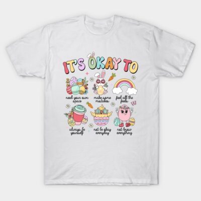 White t-shirt with colorful "It's Okay To" motivational graphics, casual style, perfect for everyday wear.