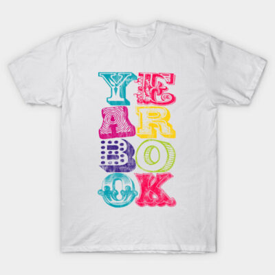 White t-shirt with colorful "Yearbook" graphic design in various fonts, casual wear, cotton material.