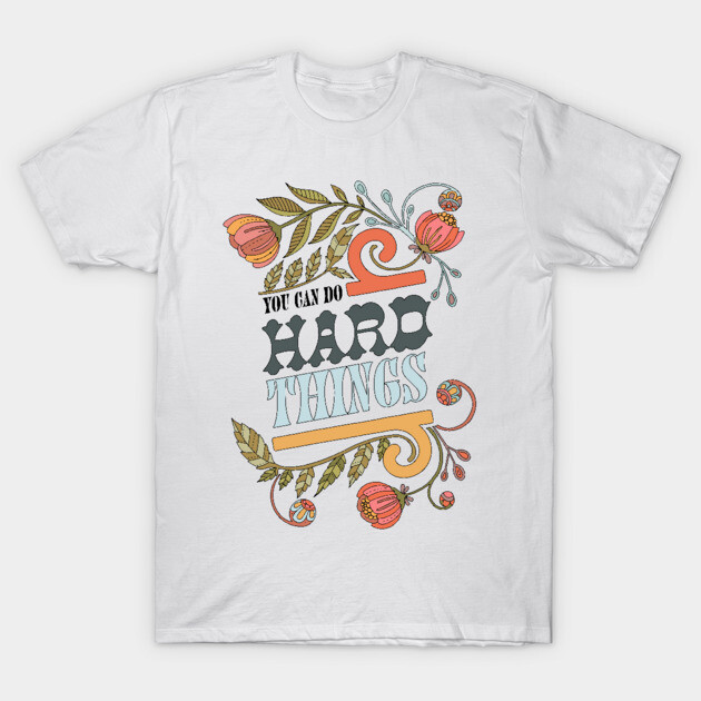 White t-shirt with floral design and motivational "You Can Do Hard Things" text, casual wear, cotton material.