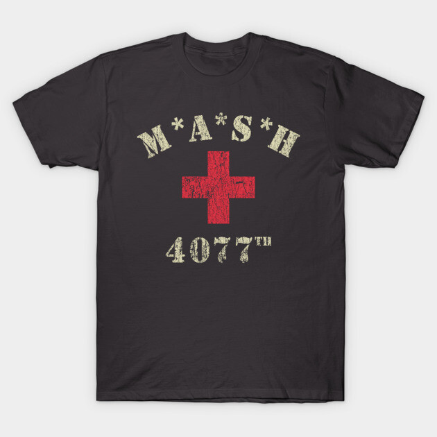 Black t-shirt with vintage MASH 4077 design, featuring a distressed red cross graphic. Cotton material, casual style.