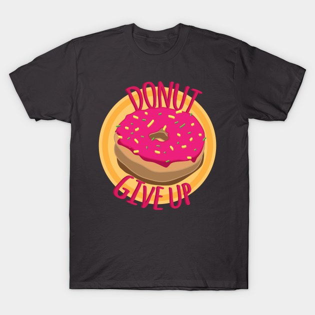Black t-shirt with pink donut graphic and "Donut Give Up" text, casual wear, cotton material, fun design.