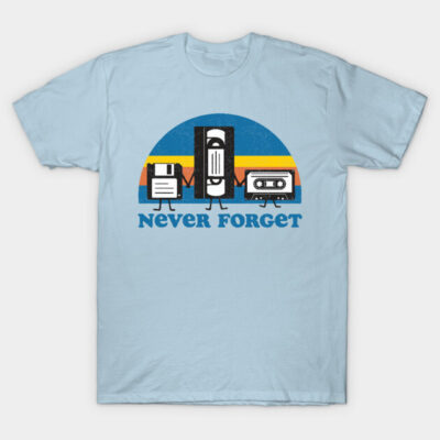 Light blue t-shirt with retro "Never Forget" graphic featuring floppy disk, VHS, cassette; nostalgic tech design.