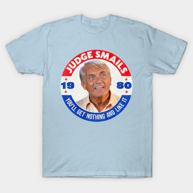 Light blue graphic T-shirt featuring retro design with bold text, casual style, perfect for everyday wear.