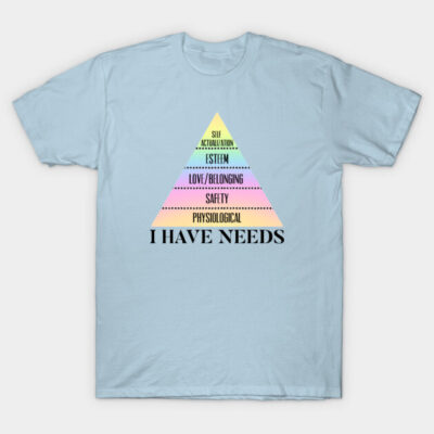 Light blue t-shirt with colorful pyramid design and "I Have Needs" text, casual wear, cotton material.