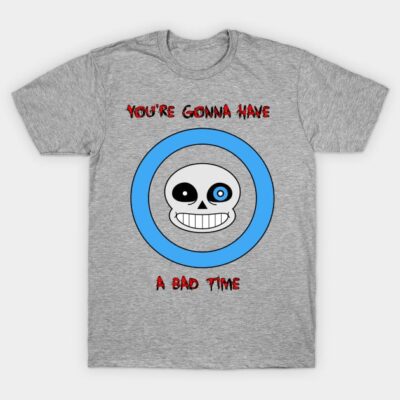 Gray t-shirt with blue circle and cartoon skull graphic, featuring red text design. Casual, cotton material.
