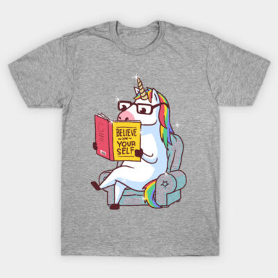 Gray t-shirt with reading unicorn print, rainbow mane, and "Believe in Yourself" book. Casual, fun cotton tee.