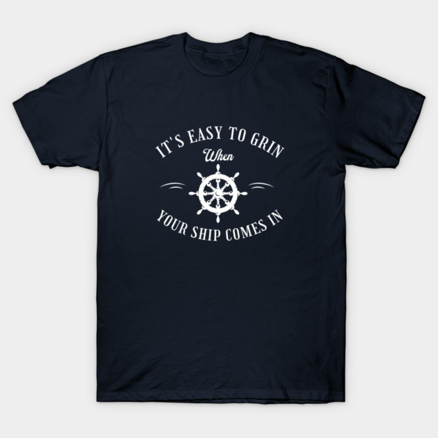 Navy blue t-shirt with nautical theme, featuring ship wheel graphic and "It's Easy to Grin When Your Ship Comes In" text.