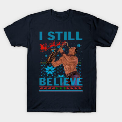 Navy blue T-shirt with "I Still Believe" text and festive saxophone player design, perfect for holiday wear.