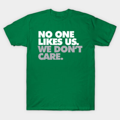 Green cotton t-shirt with bold white text "No One Likes Us. We Don't Care." Casual and comfortable style.
