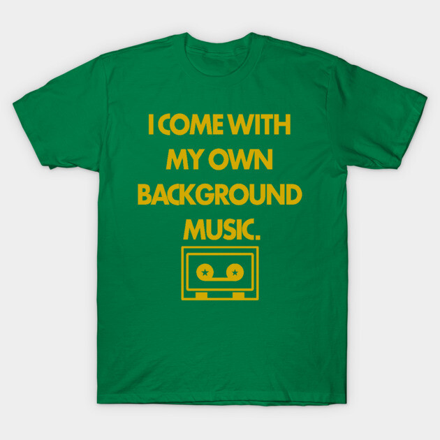 Green t-shirt with yellow text "I Come with My Own Background Music" and cassette graphic, casual wear cotton tee.