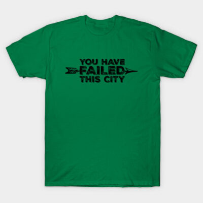 Green T-shirt with black text "You Have Failed This City," casual style, soft cotton fabric, ideal for everyday wear.